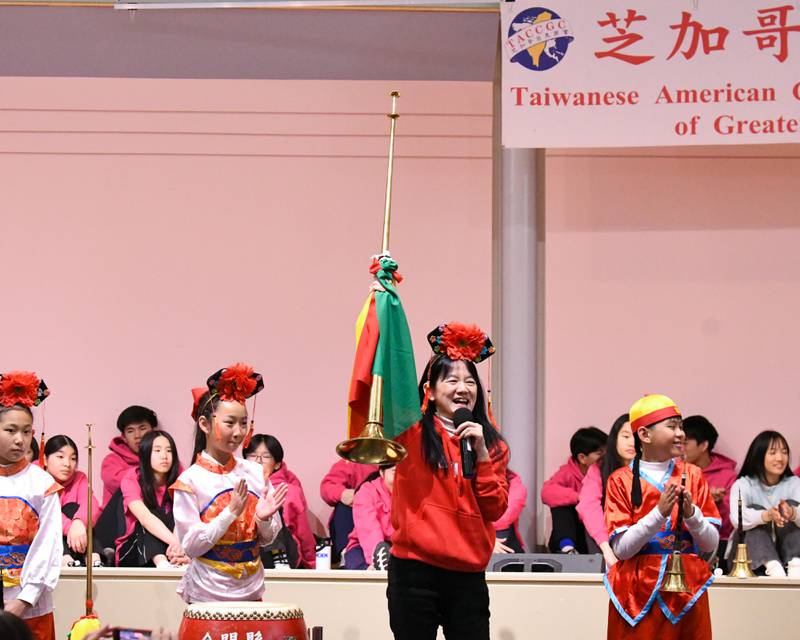 Jhong Jheng Elementary School Suona and Drum Ensemble from Kinmen, Taiwan teacher Li Lijuan shows off the long trumpet and what it’s use for during the demonstration portion of the performance on Saturday April 19, 2025, held at the Taiwanese American Chamber of Commerce building in Westmont.