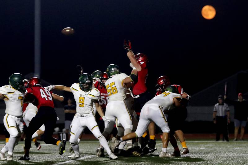 Huntley defensive players try to block a Crystal Lake South extra point as the full moon rises above the field during a Fox Valley Conference football game on Friday, Sept. 29, 2023, at Huntley High School.