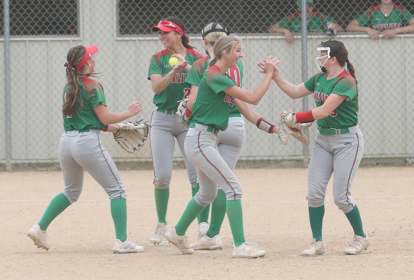 Members of the L-P softball team hi-five each other between innings against Ottawa on Wednesday, May 7, 2025 at Ottawa High School.