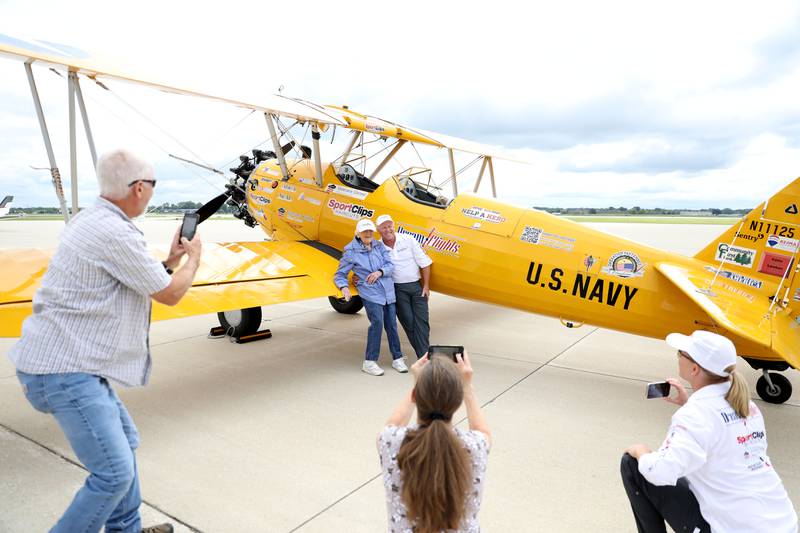 Helen Ehlers, 99, of Wheaton poses for a photo with pilot Darryl Smith following a Dream Flight at the DuPage Airport in West Chicago on Saturday, July 29, 2023. The plane is a 1942 open cockpit Boeing Stearman, the same airplane used to train military aviators in the 1940s. The flights were courtesy of Ageless Aviation Dreams Foundation, a non-profit organization to honor U.S. military veterans living in long-term care facilities. Ehlers is a United States Marine Corps veteran.