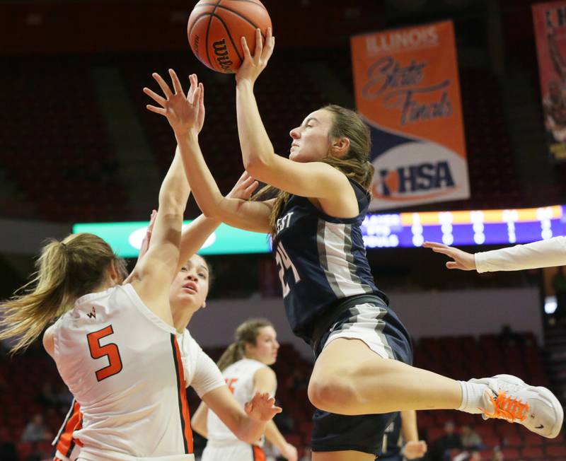 Fieldcrest's Ashlyn May (24) looks to shoot a basket as Winnebago's Renee Rittmeyer (5) defends in the Class 2A State semifinal girls basketball game on Thursday, March 3, 2022 at Redbird Arena in Normal.