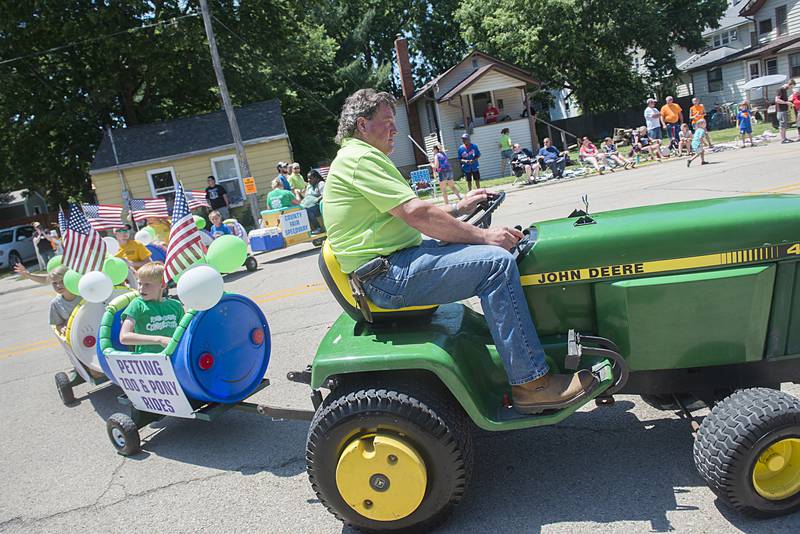 Kids are hauled through the parade Sunday, July 3, 2022 as part of the Lee County 4H fair entry.