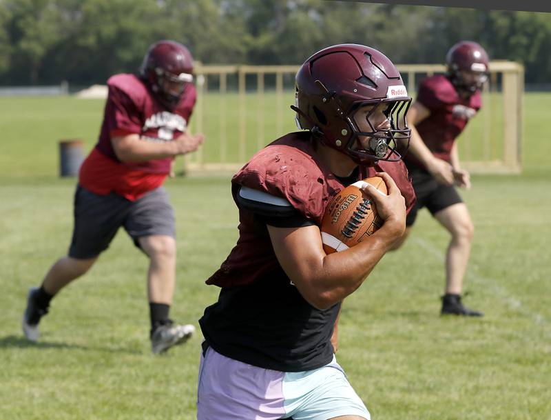 Marengo’s Gavin Baros runs with the football during football practice on Tuesday, July 22,  2025, at Marengo High School.