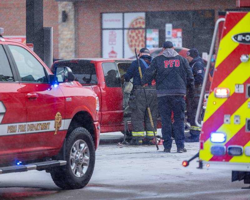 Peru Firefighters dismantle electrical in vehicle at scene of internal electrical fire of vehicle near gas pump on Tuesday, December 30, 2025 at Casey's on 1100 Shooting Park Road in Peru. The fire was extinguished by 15 year old driver Jesus Gonzalez of Streator.