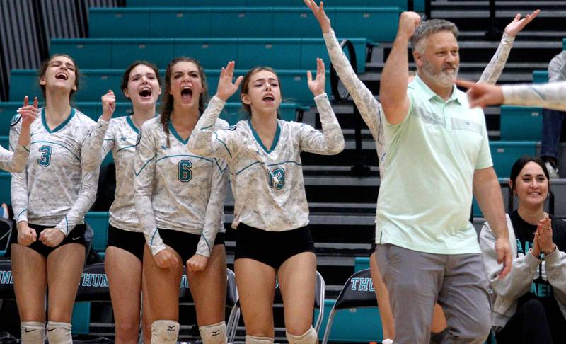 Head Coach Eric Schulze and the Woodstock North Thunder celebrate a point against Richmond-Burton in varsity volleyball at Woodstock Monday night. The Thunder fell in three sets to the Rockets.
