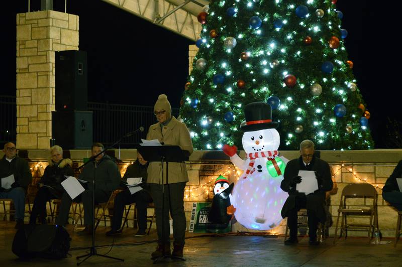 Nancy Stockwell, of Beacon of Hope Hospice, reads the names of lost loved ones during the Love Light Tree ceremony that's part of Rock Falls' annual Hometown Holidays celebration on Friday, Nov. 17, 2023, in RW&B Park.