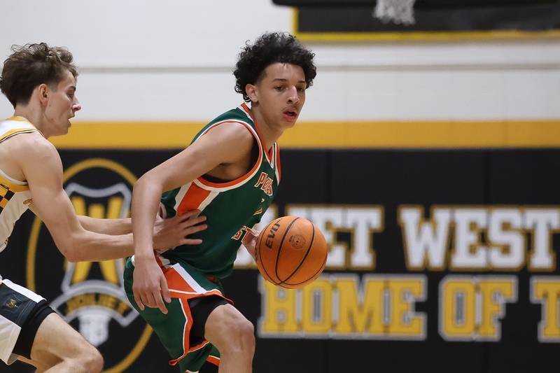 Plainfield East’s Kierre Miller looks for a play against Joliet West on Friday, Dec. 19, 2025 in Joliet.