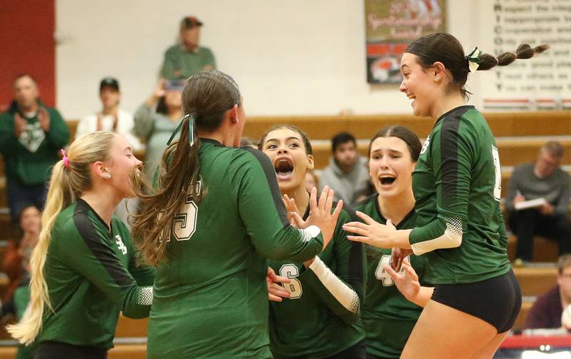 Members of the St. Bede volleyball team react after pulling off a upset over Henry-Senachwine on Tuesday, Oct. 21, 2025 at Henry-Senachwine High School.