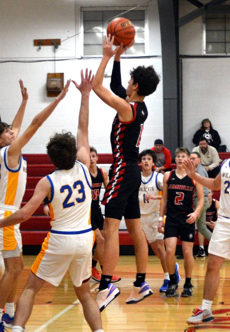 LaMoille's Tyler Billhorn rises above the crowd for a shot against Galva in the third-place game of the LaMoille Holiday Classic on Friday. The Lions won 54-51.