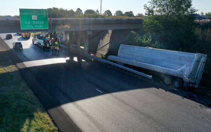 Emergency crews work the scene of a semi truck that struck the overpass of Illinois Route 251 and Interstate I-80 on Friday, Sept. 26, 2025 in Peru. The driver of the semi had to be extricated. Illinois State Police, Peru Fire and EMS, Senica Towing and Illinois Department of Transportation were all on the scene.