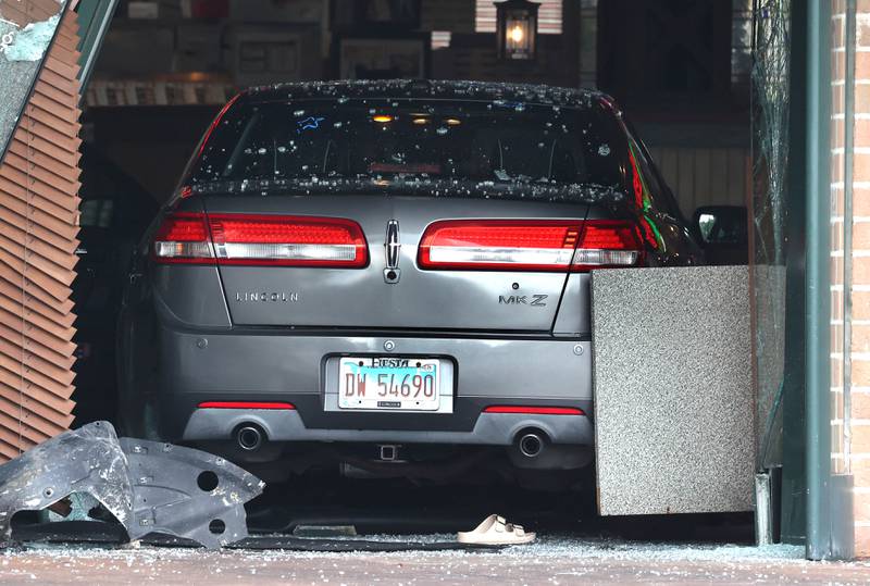 A sandal lies behind a car Wednesday, July 30, 2025, after it crashed through the front entrance of the Portillo’s at 2810 U.S. Route 34 in Oswego injuring 12.