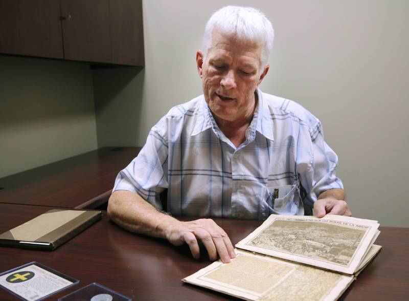 DeKalb resident John Wright talks Monday, Oct. 7, 2024, about the service record book of WWI U.S. Army soldier Albert Leonhard that he bought at a local estate sale.
