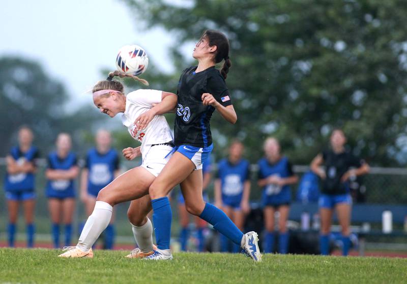 St. Charles East’s Tatum Smith (left) heads the ball ahead of St. Charles North’s Aubri Magana during a Class 3A South Elgin Sectional semifinal game on Tuesday, May 21, 2024.