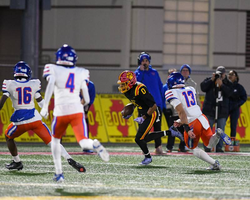 Batavia's Darin Ashiru (0) runs the ball during the first round of playoff against Hoffman Estate on Friday Oct. 31, 2025, held at Batavia High School.