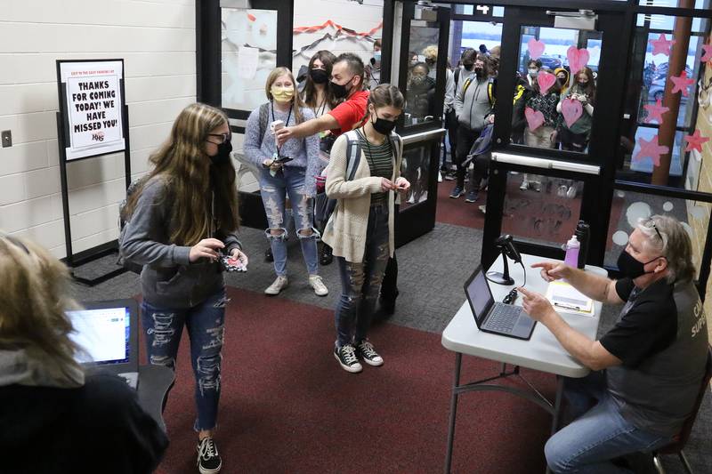 Students filter into Huntley High School on the first day back to hybrid learning in Huntley School District 158, incorporating a split between remote and in-person learning, on Monday, Jan. 25, 2021, in Huntley.