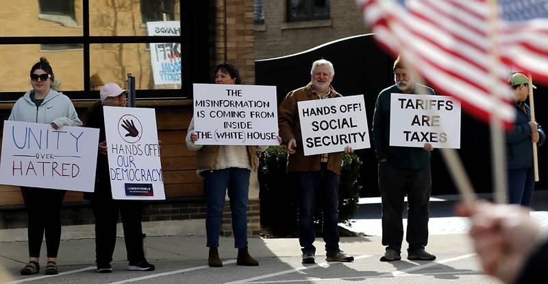 Protesters line U.S. Route 12 in Richmond to protest their discontent with President Donald Trump and his administration's policies on Saturday, April 19, 2025. Over 100, people took part in the Richmond protest. A second rally was held in Harvard later in the day.