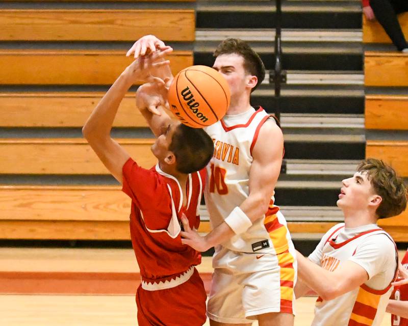 Hinsdale Central's Blaze Burt (4) gets fouled by Batavia's Joseph Reid (10) during the game on Saturday Jan. 24, 2026, held at Batavia High School.