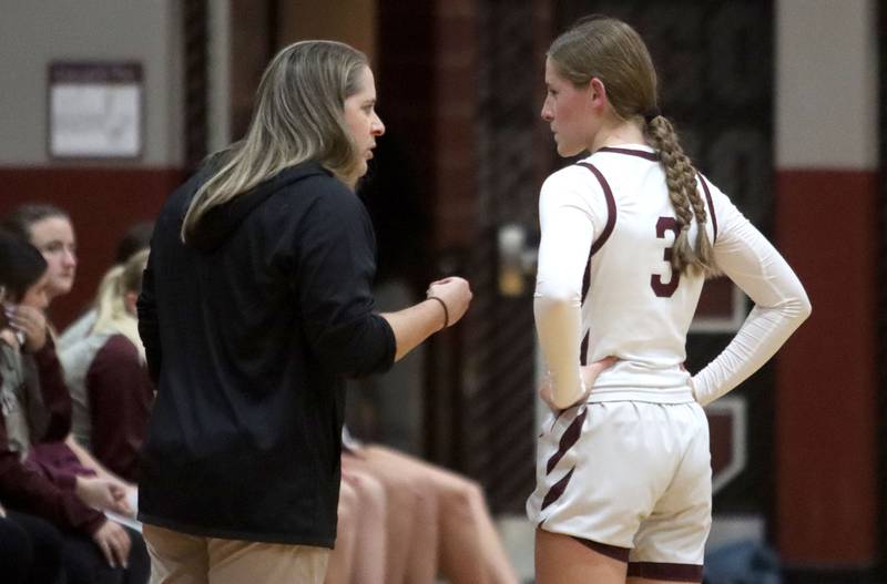 Marengo’s Head Coach Elisa Hanson speaks with Maggie Hanson as the Indians play Woodstock North in varsity girls basketball on Tuesday, Dec. 2, 2025, at Marengo High School in Marengo.