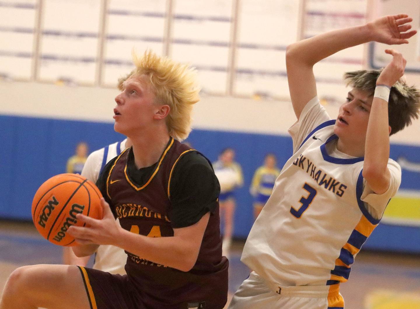 Richmond-Burton’s Ray Hannemann, left, gets past Johnsburg’s Trey Toussaint in varsity boys basketball onTuesday, Dec. 9, 2025, at Johnsburg High School in Johnsburg.