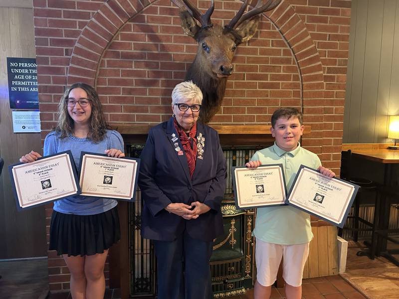 Brooklyn Mauch (left) and Paul Hochstatter (right), 6th grade essay winners for the Mendota Elks Essay Contest, are joined by Dessa Collings (center), Mendota Elks Exalted Ruler.