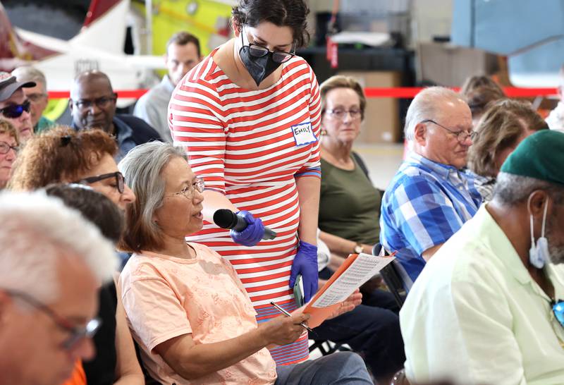 An audience member asks a question of U.S. Rep. Lauren Underwood, D-Naperville, Tuesday, Aug. 23, 2022, during a town hall meeting in one of the hangers at the DeKalb Taylor Municipal Airport.