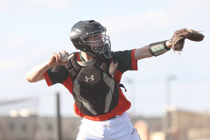 Plainfield East’s Josh Tarnowski throws to first on a dropped third strike against Bolingbrook on Monday, March 27, 2023.