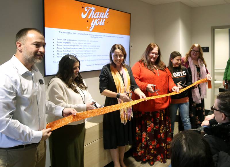 DeKalb School District 428 representatives along with teachers in the district’s transitional program cut the ribbon Wednesday, Jan. 22, 2025, during the grand opening celebration of the Beyond One Barb Transition Center in DeKalb. The the transition program has been in place to facilitate students with intellectual and developmental disabilities aged 18-22 into adulthood and independent living.