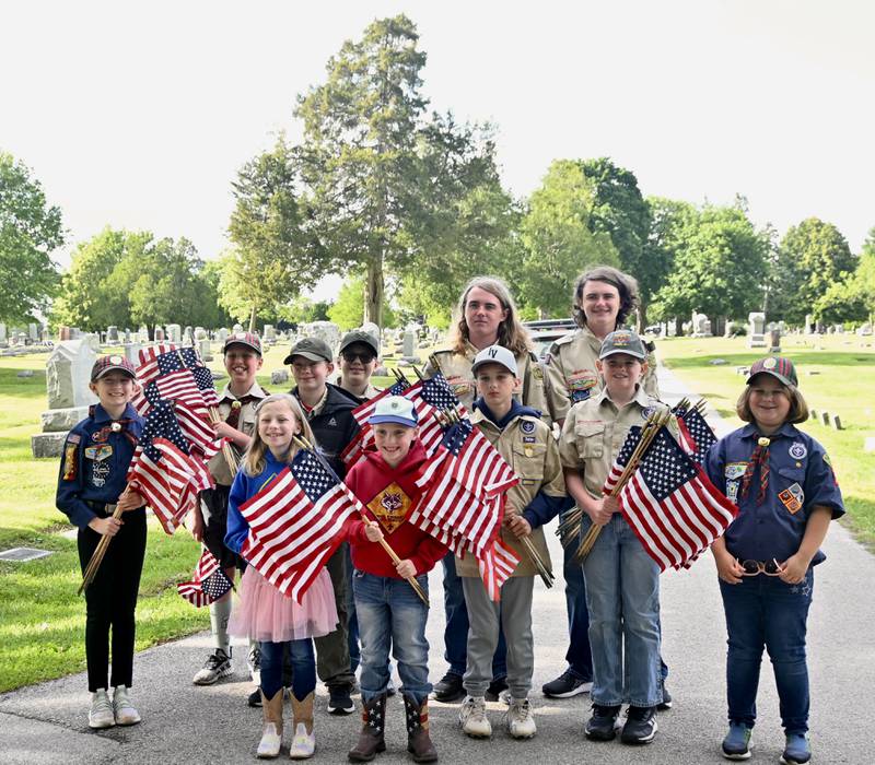 Avalean Arnald, Logan Freed, Peony Lester, Finn Paul, Noah Lester, Maksym Wroblewski, Evan Hall, Zayden O'Dell, Killian O'Dell, Desmond O'Dell and Liberty Wroblewski, of Boy Scouts from Peru's Troop 123 and Peru Cub Scouts from Pack 3709,  were on hand Thursday, May 22, 2025 to place flags at gravesites of 1,000 veterans ahead of Memorial Day at Peru City Cemetery.