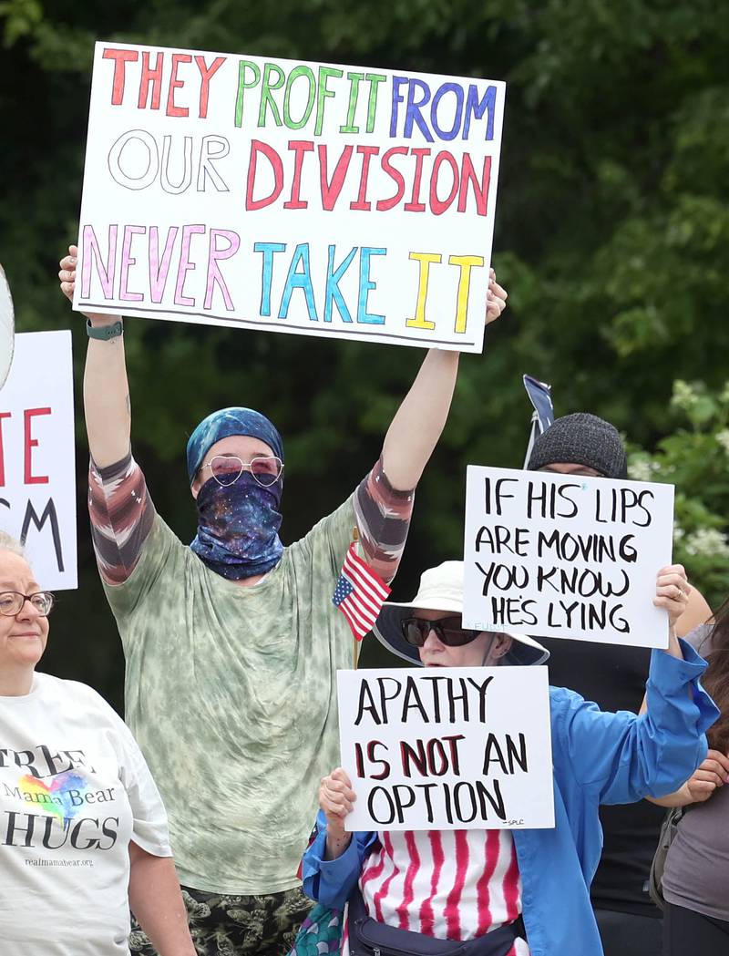 A protester holds a sign Saturday, July 4, 2025, at the corner of Main and State Streets in front of the DeKalb County Courthouse in Sycamore during a "No Kings" rally to voice their displeasure with President Donald Trump.