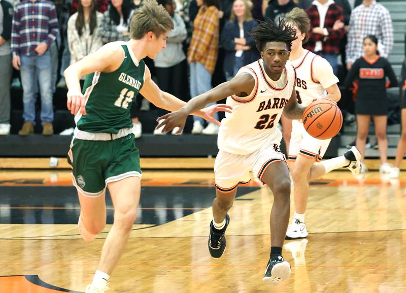 DeKalb's Darrell Island gets the ball up the court against the defense of Glenbard West’s Dominick Seaney during their game Tuesday, Nov. 29, 2022, at DeKalb High School.