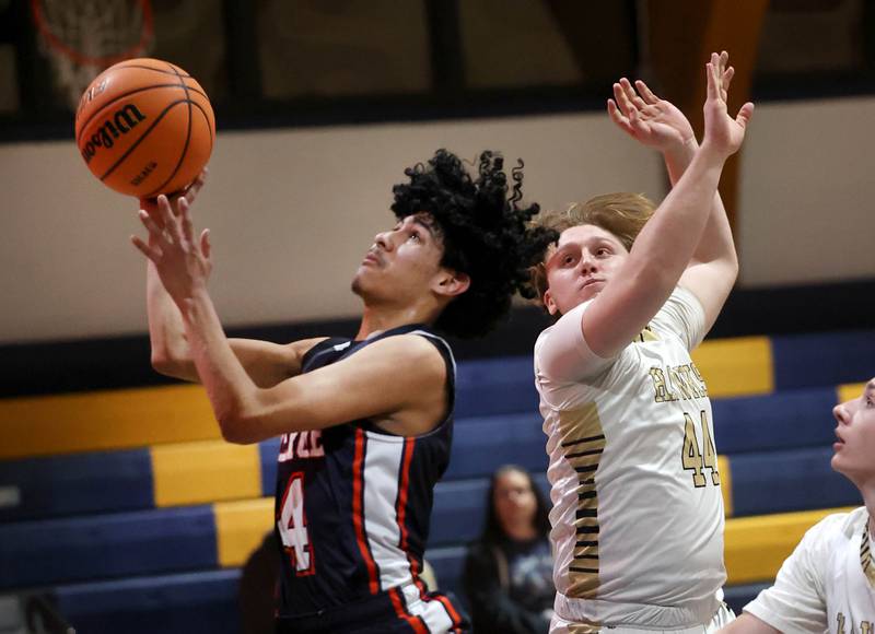 DePue’s Deigo Perez splits two Hiawatha defenders during their game Tuesday, Jan. 20, 2026, at Hiawatha High School in Kirkland.