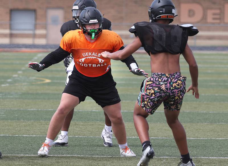 DeKalb’s Owen Sisson sets up to pass block Wednesday, July 15, 2025, during a summer practice session at the school.