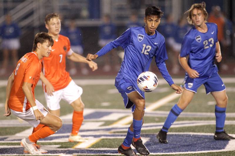 St. Charles North’s Diego Torres (center) gets control of the ball during a Tri-Cities Night game against St. Charles East at St. Charles North on Thursday, Sept. 21, 2023.