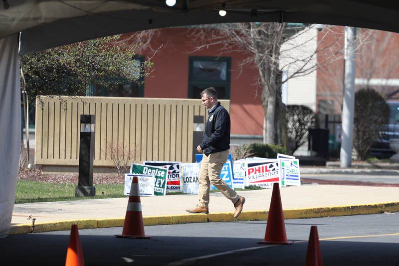 A person walks past campaign signs as they enter the Will County Office Building on Tuesday, March 19, 2024 in Joliet.