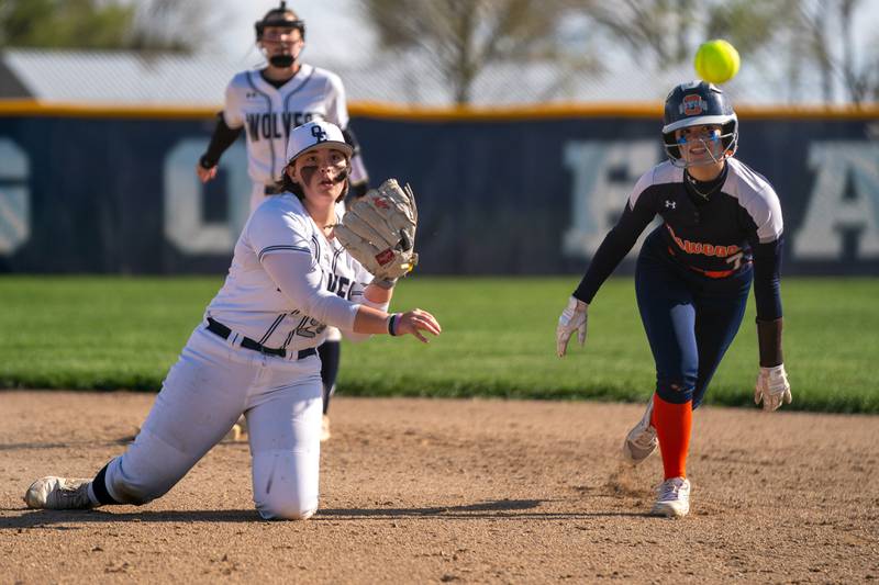 Oswego East's Renee Sinta (24) catches a line drive and throws to first for a double play against Oswego during a softball game at Oswego East High School on Friday, April 21, 2023.