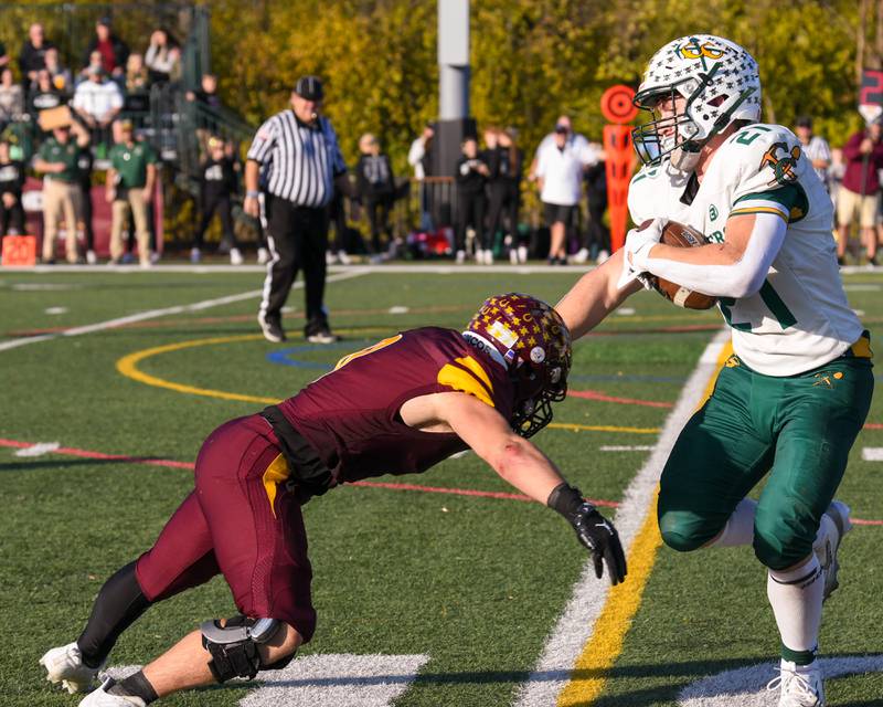Coal City's Logan Natyshok, right, tries to block Montini Catholic's Laddie Asay to gain extra yards during the 4A quarterfinals game on Saturday Nov. 15, 2025, held at Montini Catholic High School.