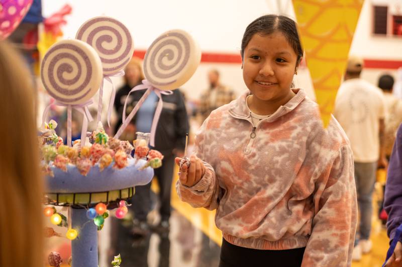 Child picks lollipop at the annual Easter Egg hunt on Saturday, April 12, 2025 at Hall High School in Spring Valley.