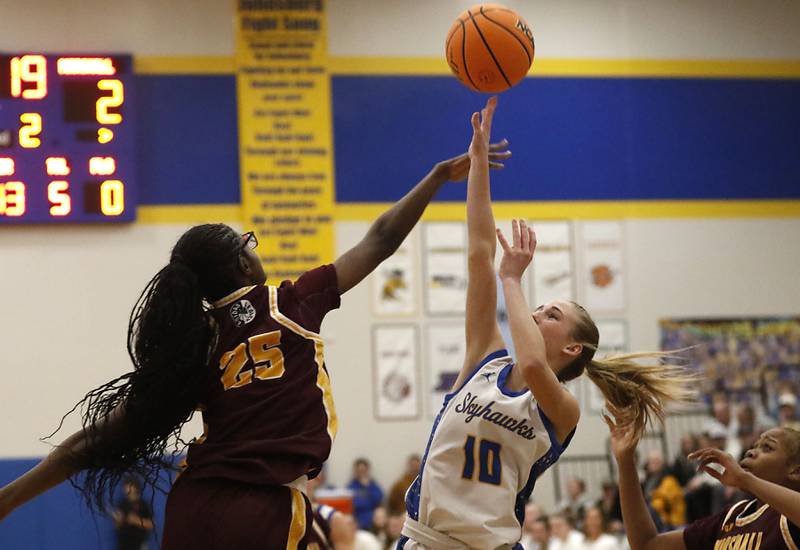 Johnsburg's Addison Sweetwood shoots the ball over Chicago Marshall's Chamarre Scott during a IHSA Class 2A Johnsburg Sectional girls basketball semifinal game on Tuesday, February, 24, 2026, at Johnsburg High School.
