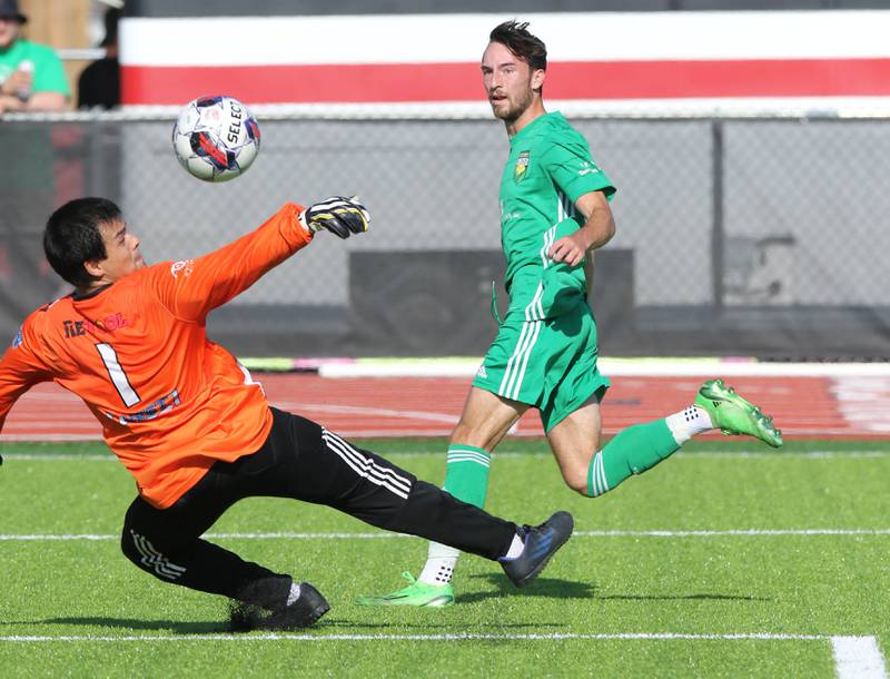 DeKalb County United's Josh Johansen gets the ball past the Rockford FC keeper during their game Saturday, July 29, 2023, at the Soccer & Track and Field Complex at Northern Illinois University in DeKalb.