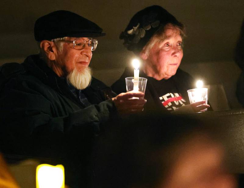 Visitors sit in quiet reflection while holding their candles Monday, Feb. 2, 2026, during the Vigil for Peace at the First Congregational United Church Of Christ in DeKalb. The vigil is being held in remembrance of those lost in recent ICE related shootings and to show solidarity with the people of Minnesota.