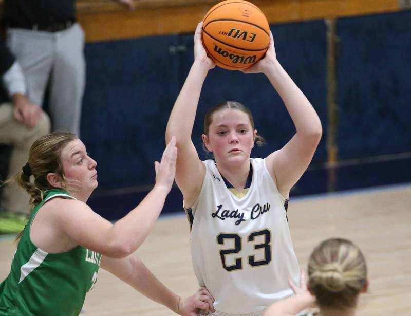 Marquette's Kelsey Cuchra passes the ball around Seneca's Tessa Krull on Thursday, Dec. 5, 2024 in Bader Gym at Marquette High School.