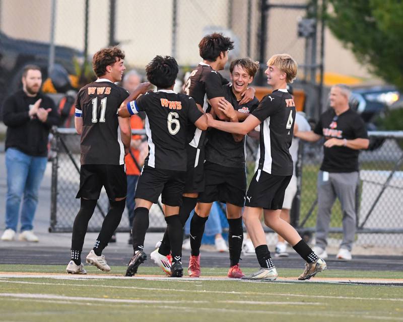 Wheaton Warrenville South's Semin Razman, second from right, is all smiles while getting congratulated by teammates after scoring a goal in the game against Wheaton North on Thursday Sept. 11, 2025, held at Wheaton Warrenville South.
