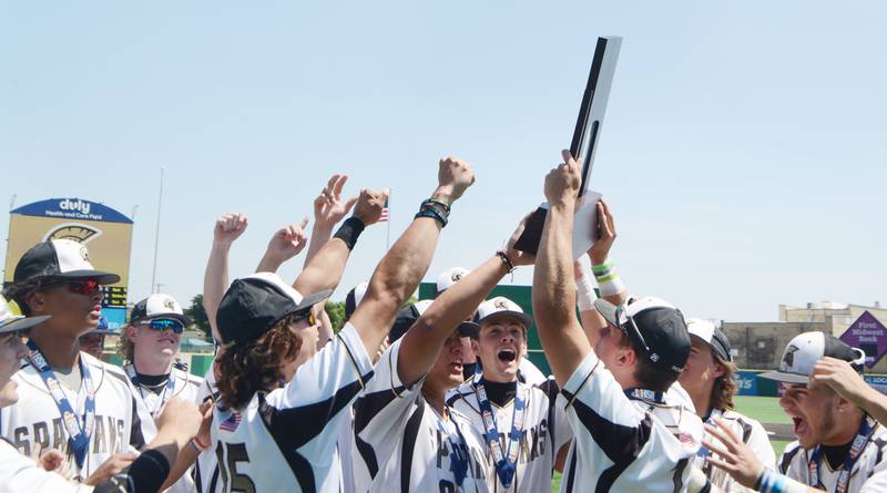 Joe Lewnard/jlewnard@dailyherald.com
Sycamore players celebrate with their trophy after defeating Effingham 2-1 in nine innings during the Class 3A  third-place state baseball game in Joliet Saturday.
