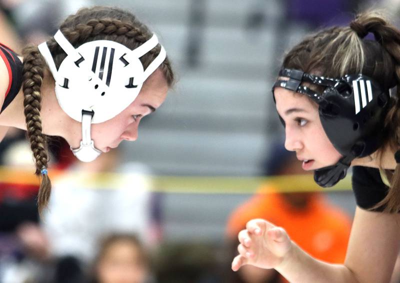 Huntley’s Aubrie Rohrbacher, left, and Jacobs’ Aryanna Geiger face off at  130 pounds in varsity girls IHSA Regional Championship wrestling action on Saturday, February 7, 2026, at Hampshire High School in Hampshire.