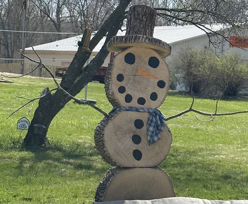 A snowman is made out of logs and sticks near the intersection of U.S. Route 6 and Park Avenue West on Thursday, April 13, 2023 in Princeton.