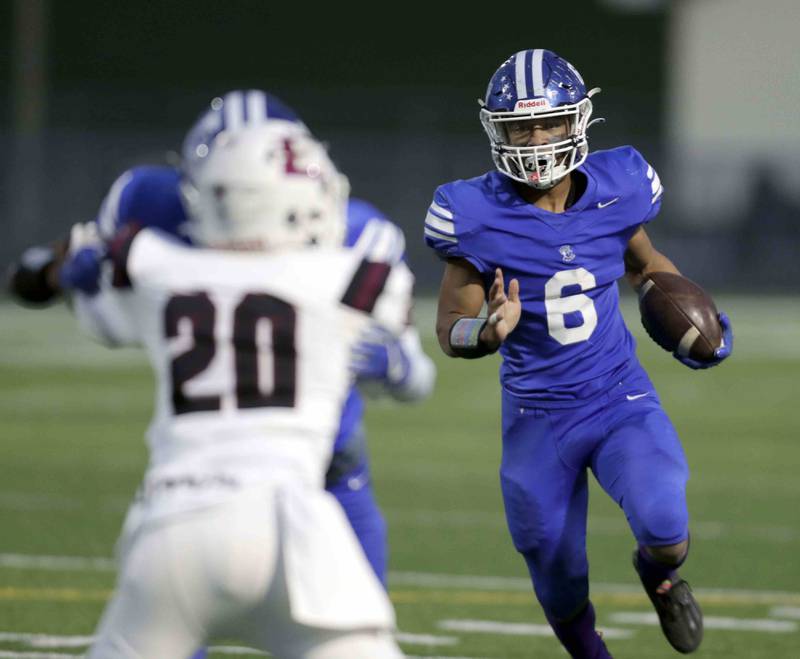 Larkin's Chevelle Clements (6) looks for running room during the annual crosstown rival game at Memorial Field  Friday October 14, 2022 in Elgin.