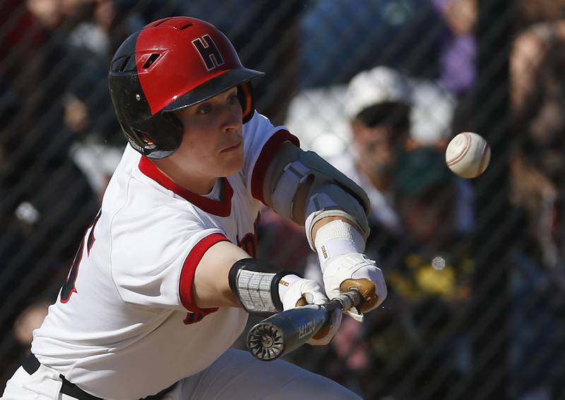 Huntley’s Michael Wanhala tries to lay down a bunt during a IHSA Class 4A baseball sectional semi-final baseball game between Jacobs and Huntley at Jacobs High School in Algonquin.