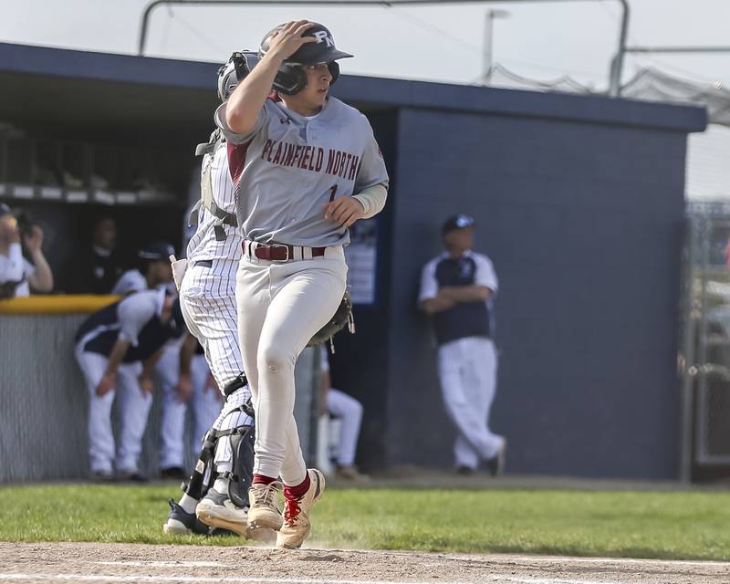 Plainfield North's (1) crosses the plate for a run during baseball game between Plainfield North at Oswego East, Monday, April 28, 2025 in Oswego.