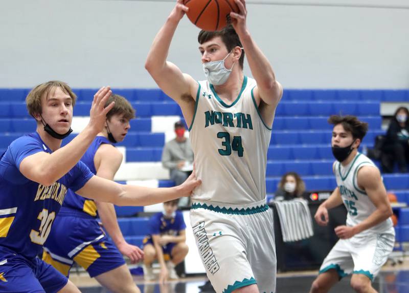 Woodstock North’s Jacob McConnell moves the ball against Wheaton North during MLK Tournament action at Burlington Central High School Saturday morning.