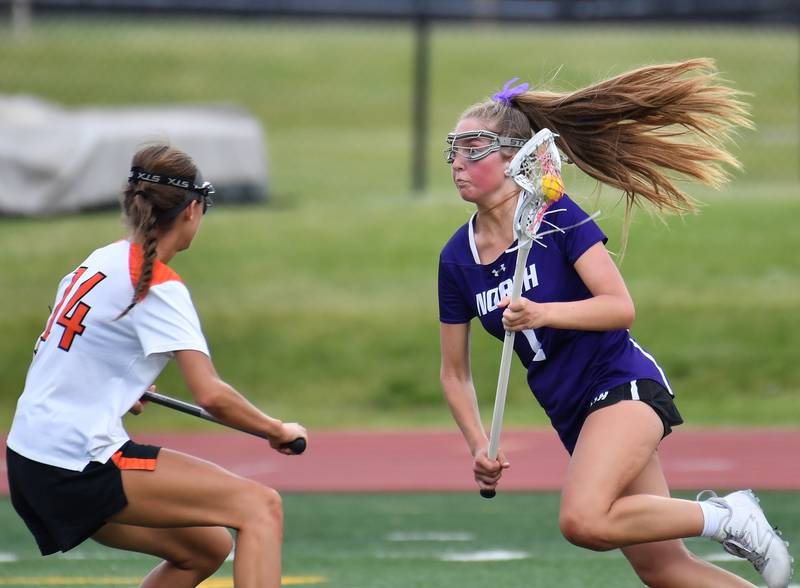 Downers Grove North’s Ella Williams races toward the goal as Crystal Lake’s Addie Bechler (14) defends during the Benet Supersectional game on June 3, 2025 at College of DuPage in Glen Ellyn.